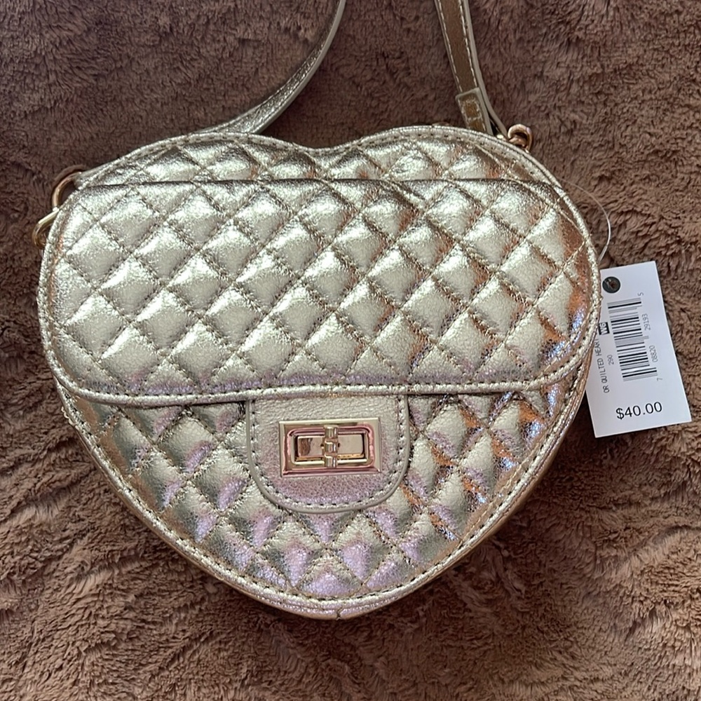 Ophelia Roe Metallic Gold Heart Purse with partial gold chain straps.